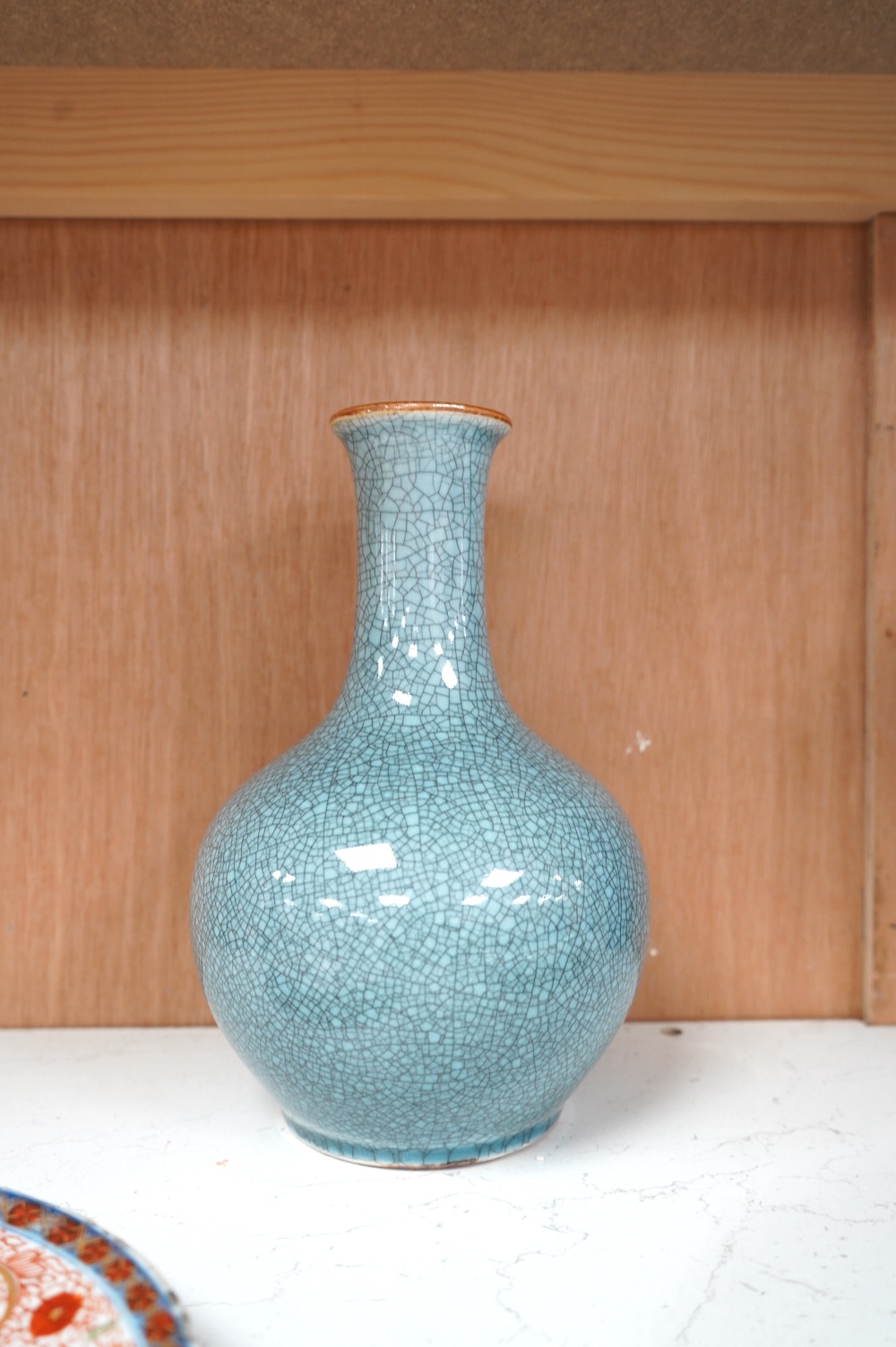 Two Chinese porcelain vases including a crackle glaze example and two plates, largest 23cm high. Condition - poor to fair